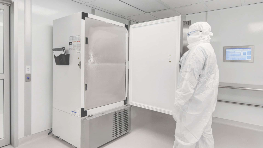 What are ISO 5 Cleanrooms? A Beginner’s Guide A scientist opens a fridge in a cleanroom environment.