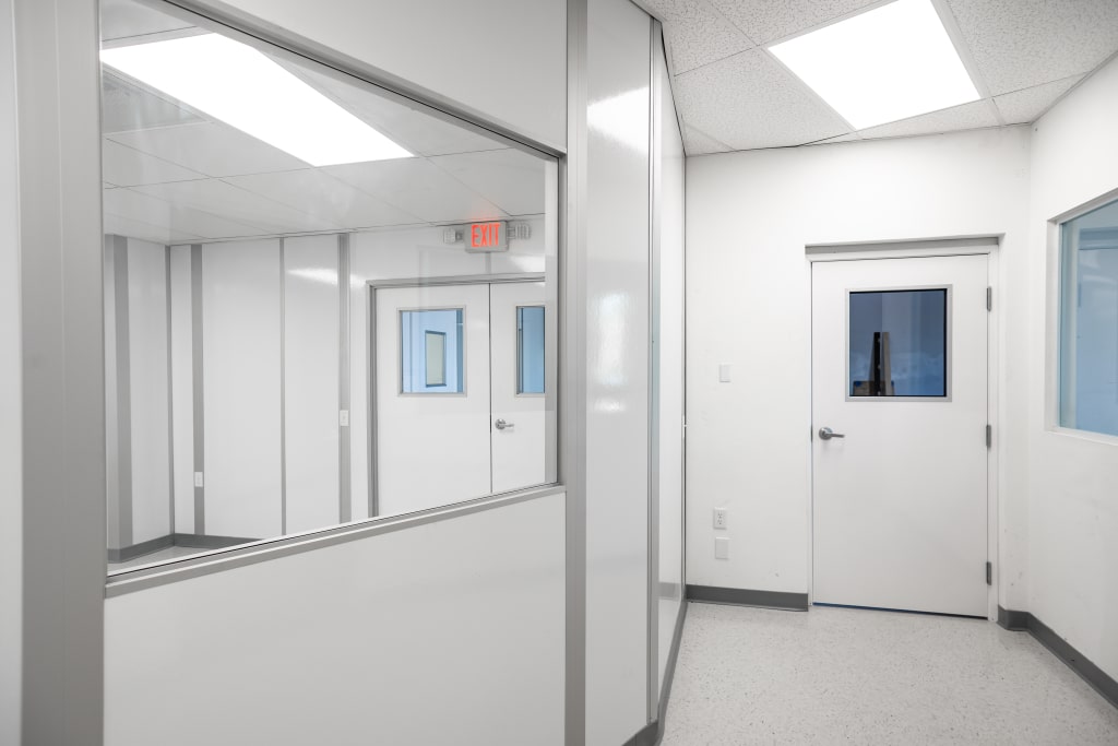 Modular cleanroom interior built by Allied Cleanrooms, featuring white walls, observation windows, and clean door systems.