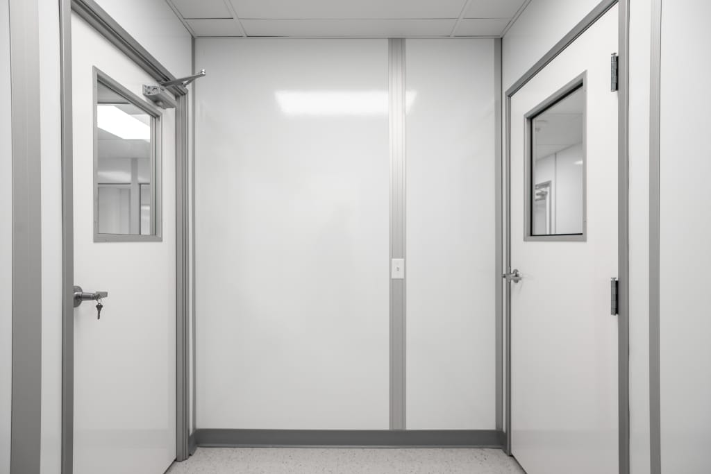 Automotive Cleanrooms: Definition, Design, and Standards Modular cleanroom interior with pre-engineered wall panels and framed doors, built by Allied Cleanrooms for controlled manufacturing environments.