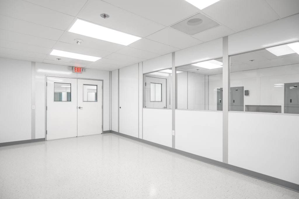 ESD Control in Cleanrooms: A Simple Guide Interior of a cleanroom with white walls, sealed windows, and bright lighting.