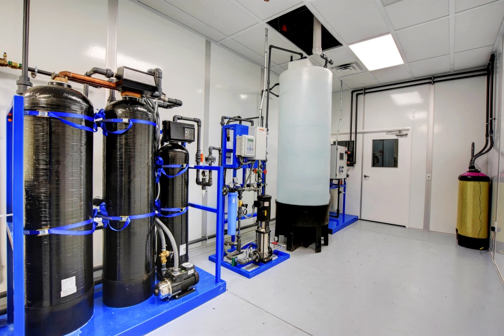 What is a Biotechnology Cleanroom? Understanding the Basics Water filtration and purification system inside a biotechnology cleanroom with large tanks, pumps, and piping.