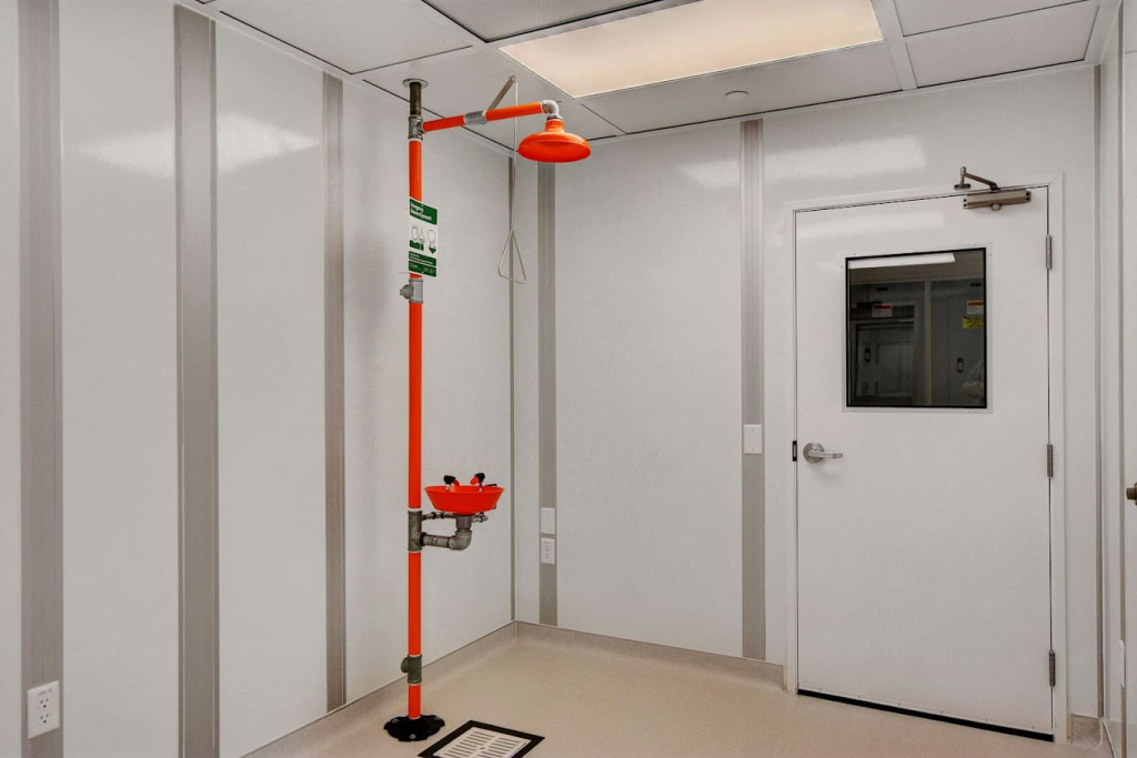 Post-Build Cleanroom Planning: What to Know Early On Emergency safety shower and eyewash station inside a modular cleanroom built by Allied Cleanrooms.