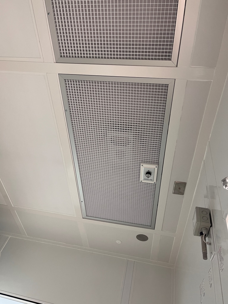 What is an ISO 6 Cleanroom? A Guide for Beginners Cleanroom ceiling with gridded panels housing HEPA filters as part of a Fan Filter Unit (FFU) system.