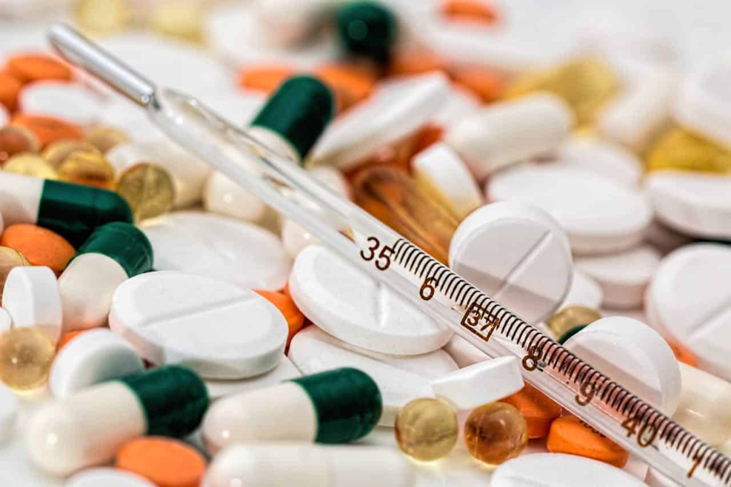 Types of Medical Cleanrooms You Should Know A variety of pharmaceutical pills and capsules with a thermometer.