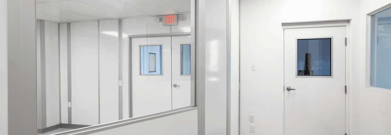 Modular cleanroom corridor with interior windows and sealed doors, built by Allied Cleanrooms for optimized post-build cleanroom planning.